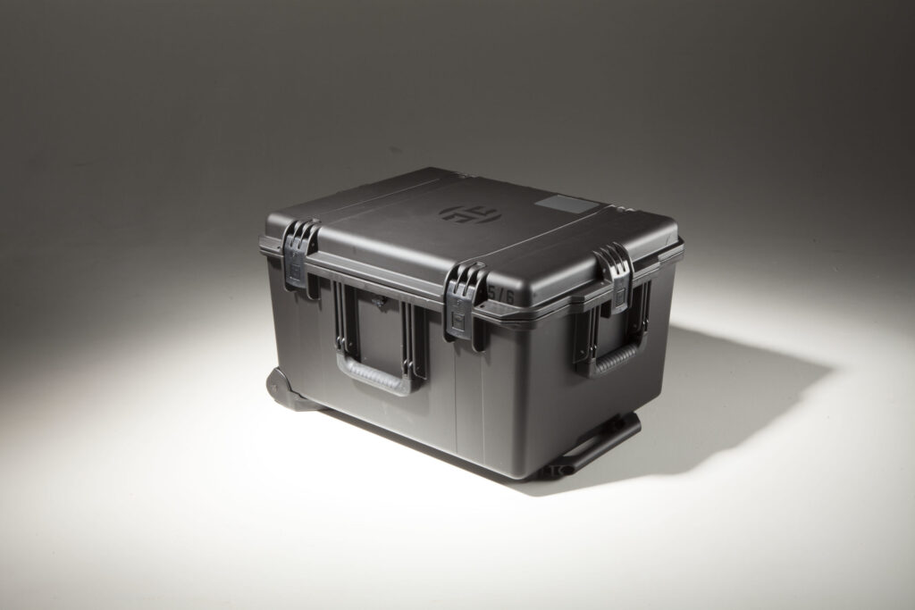 A custom black heavy-duty plastic cargo case with the Harden H logo on the lid.