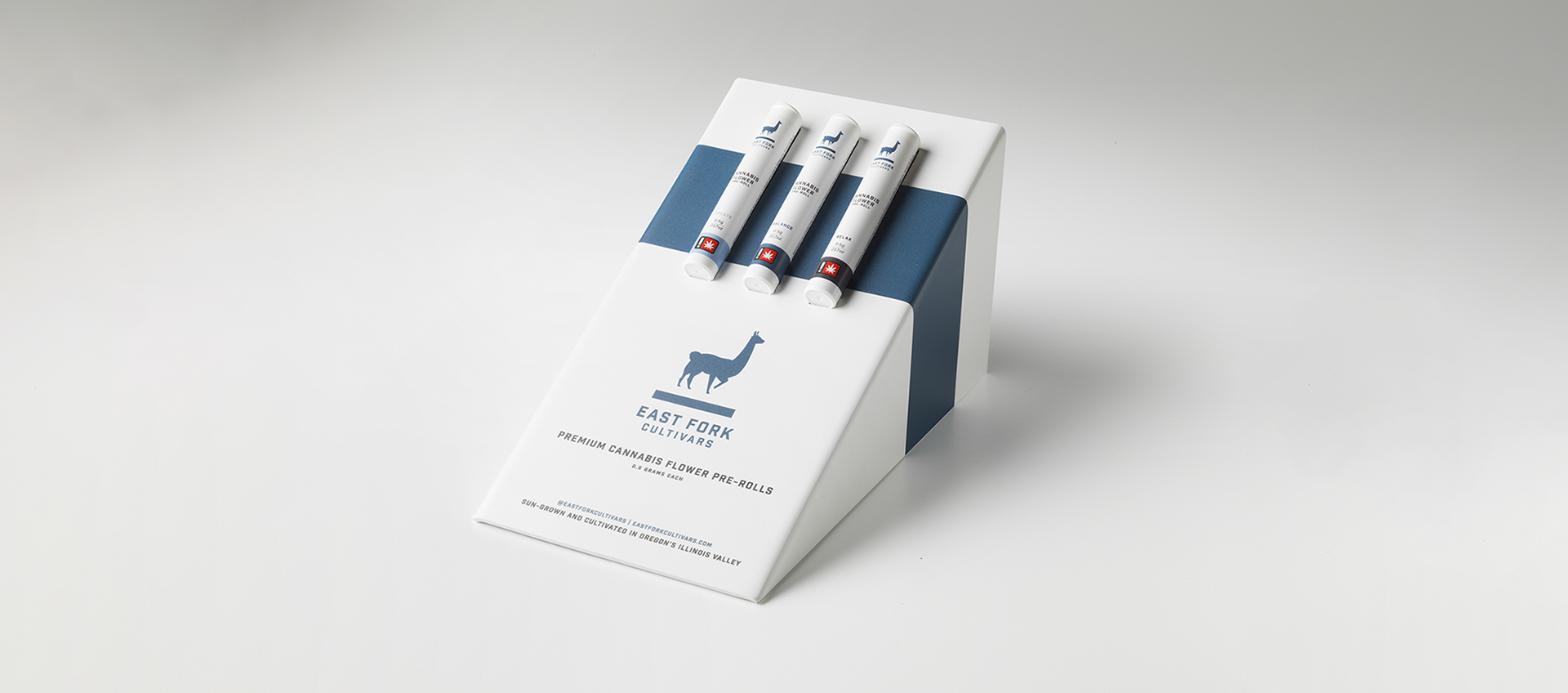 A blue and white angled display box of three East Fork pre-rolls, Create, Balance, and Relax strains.