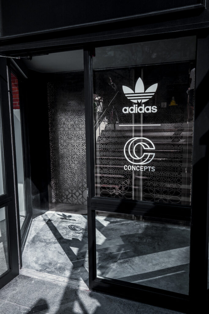 The glass front doors to the Concepts retail space, with the adidas x Concept logo lockup.