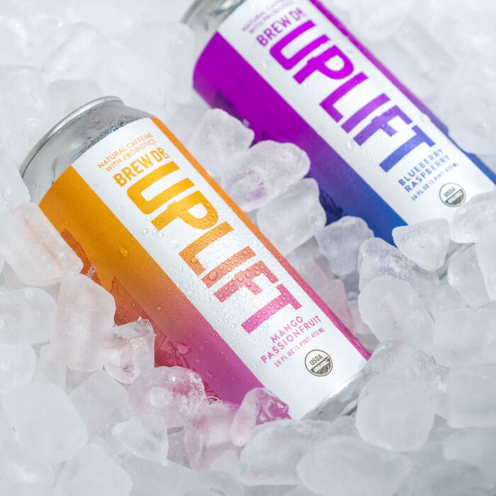 Two cans of Brew Dr. Uplift on ice.